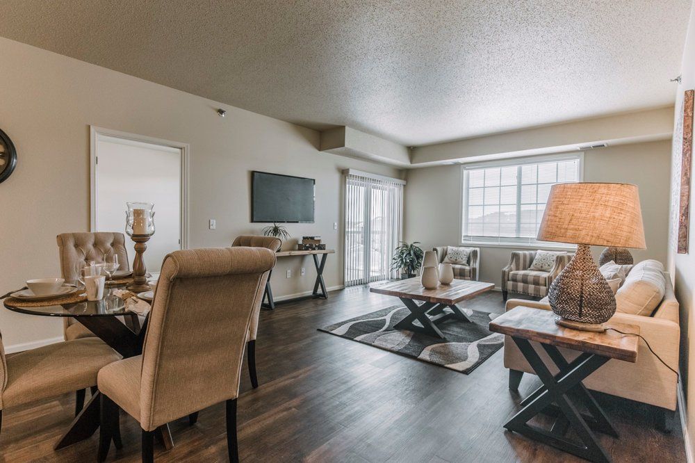 View of living room with large window and glass door leading to balcony