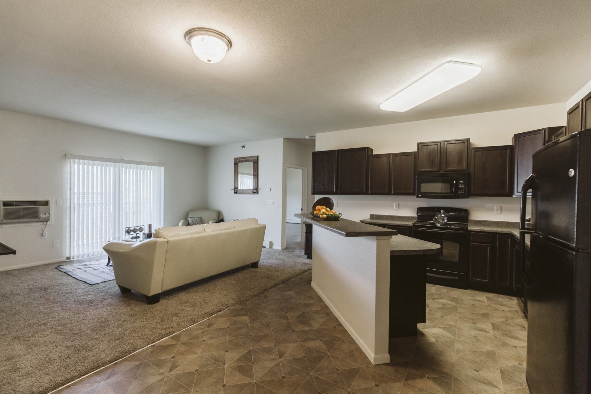 Kitchen with faux tile flooring, adjacent to living room