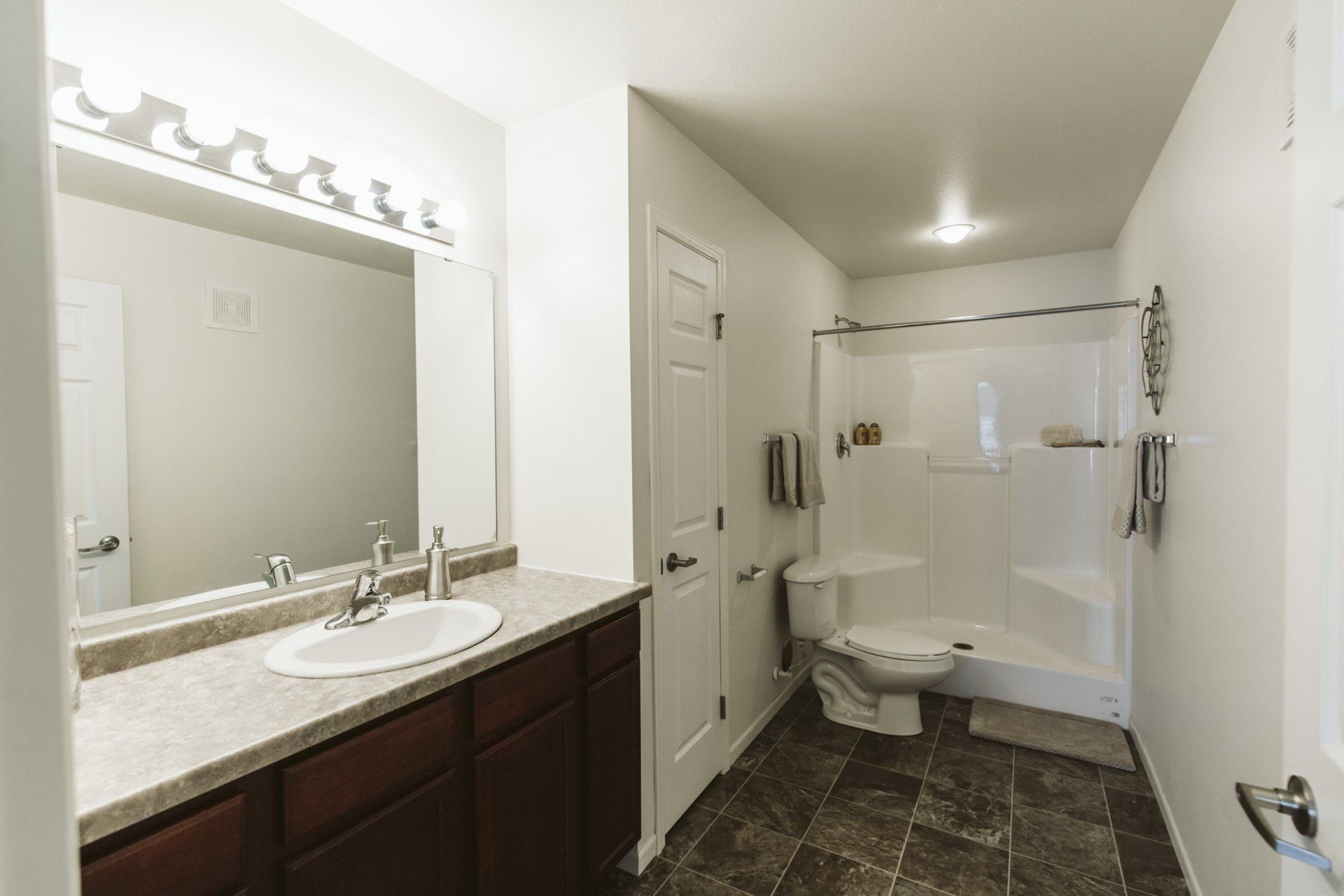 Bathroom with large vanity mirror and shower tub combo