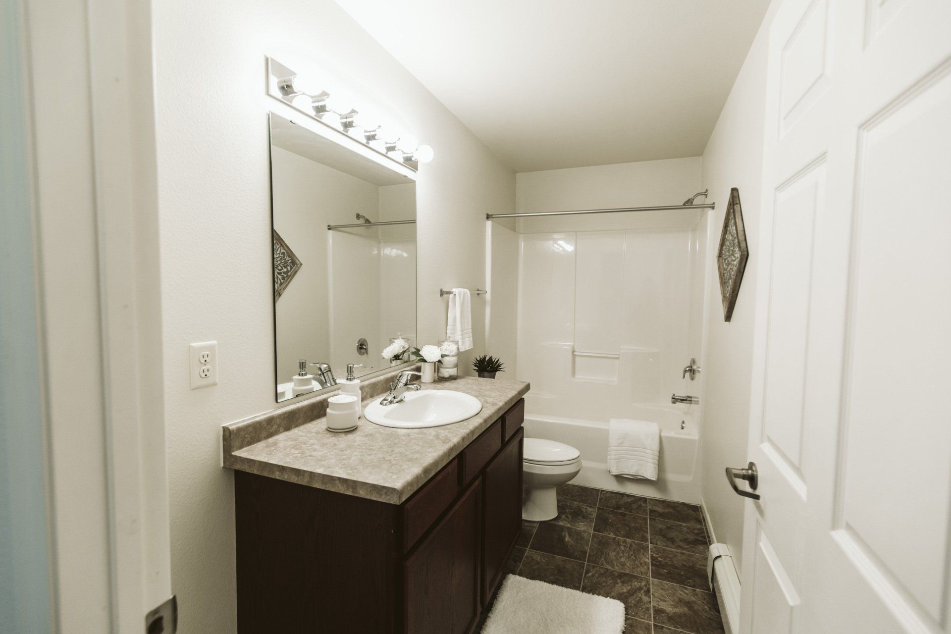 Alternate view of bathroom with large vanity mirror and shower tub combo