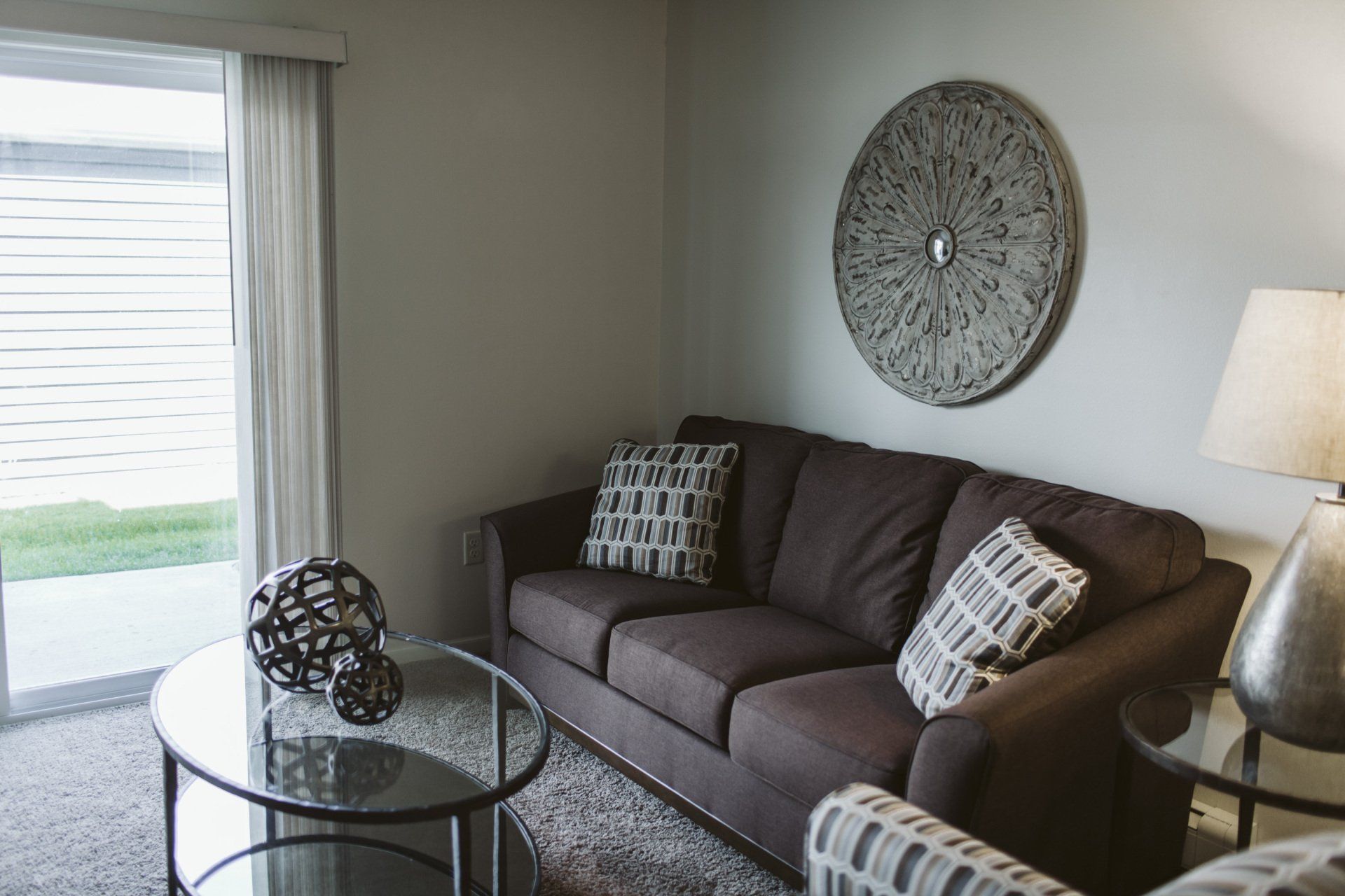 Grey sofa in carpeted living room with coffee table
