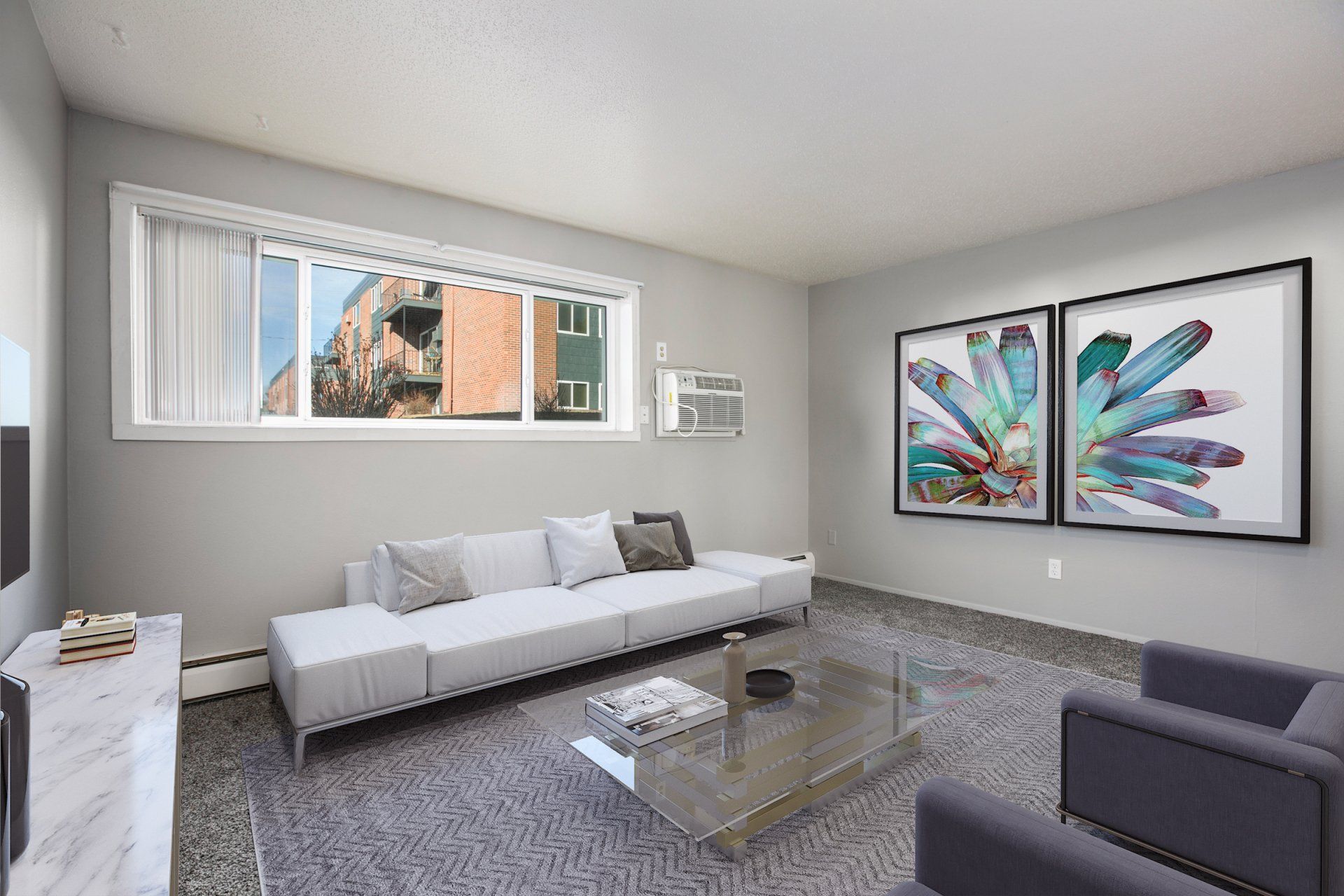Interior of carpeted living room with large horizontal window