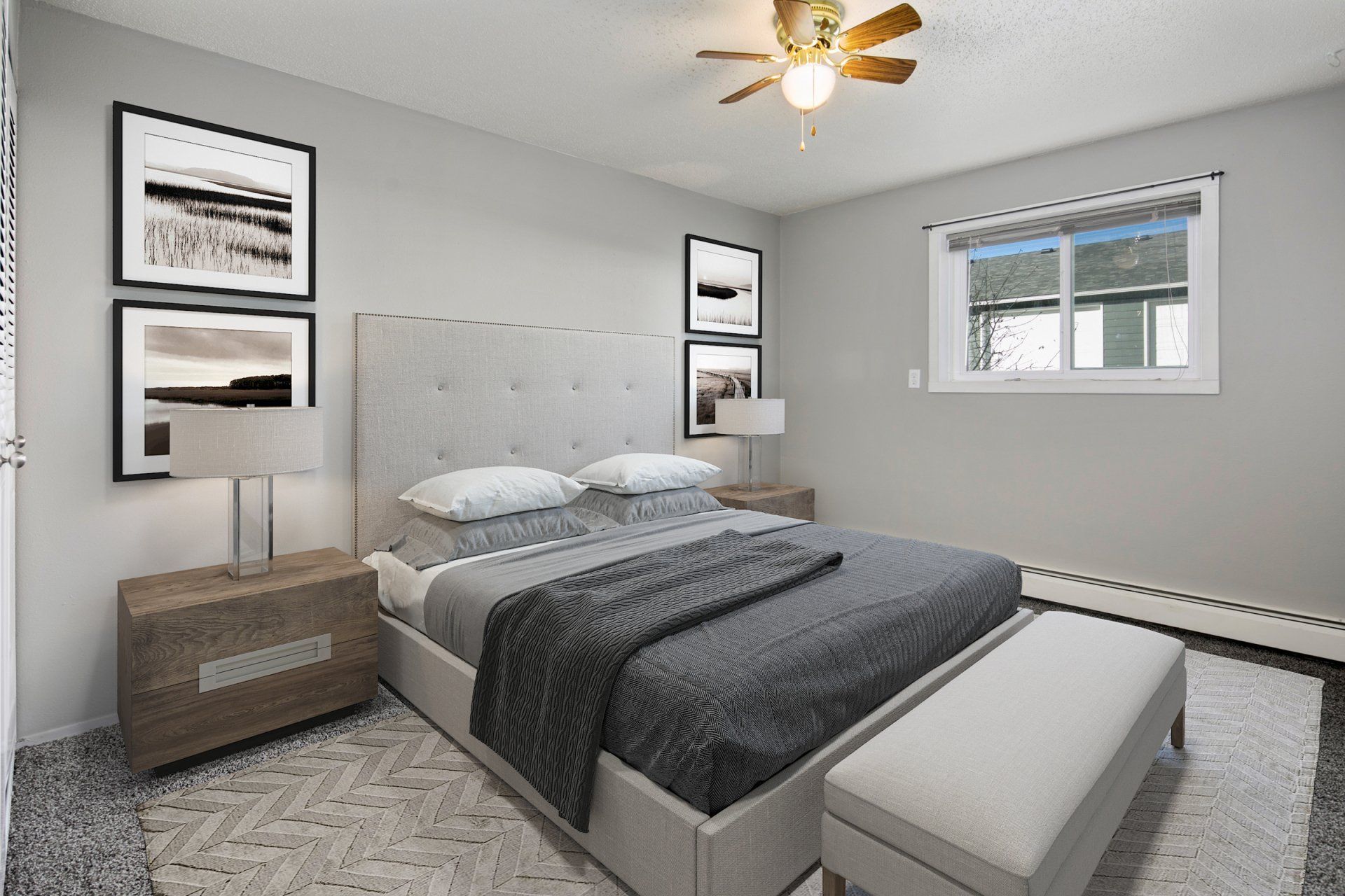 Bedroom with large horizontal window, carpeted floors, and ceiling fan