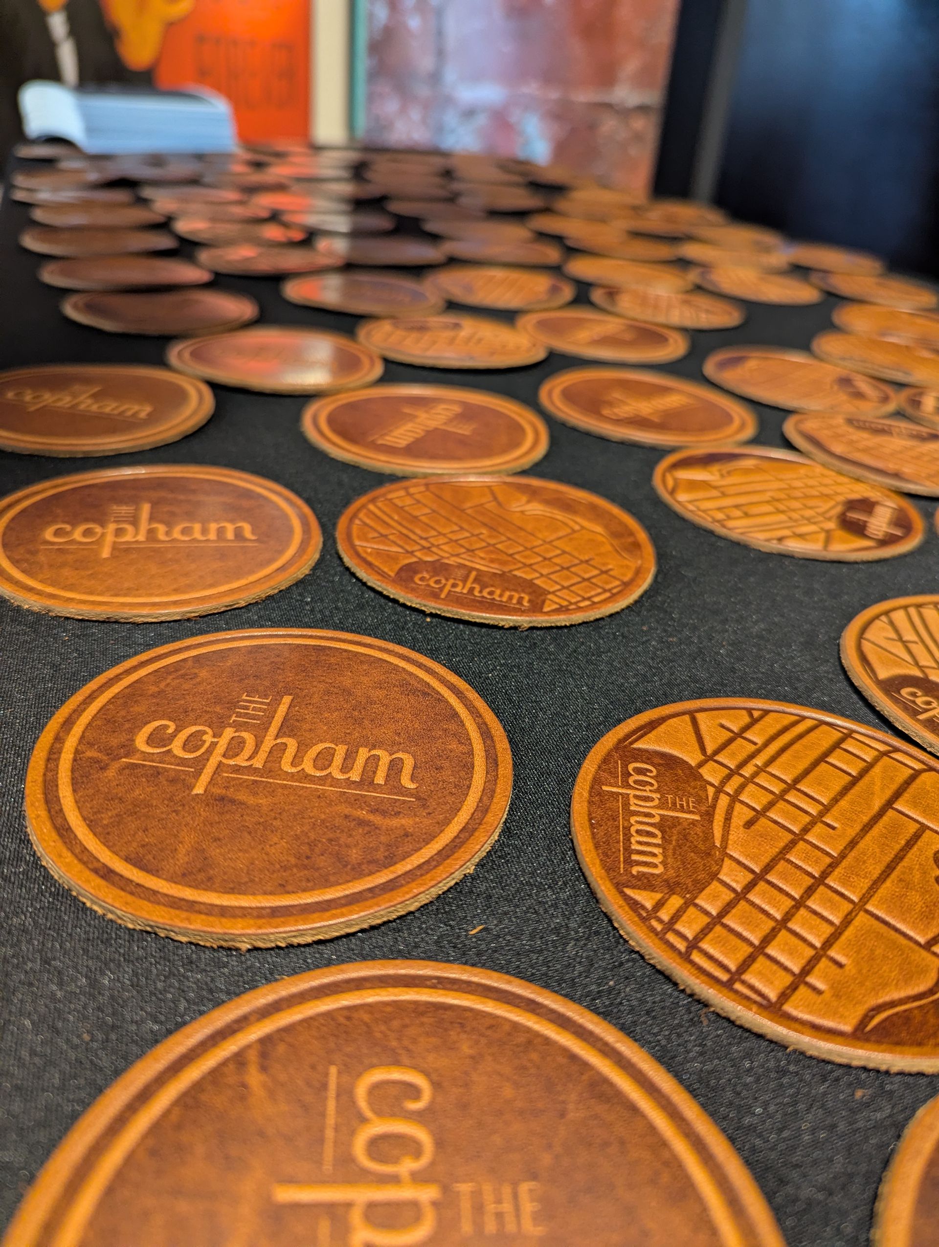 Custom coasters featuring The Copham logo and a street map of Minneapolis' North Loop neighborhood
