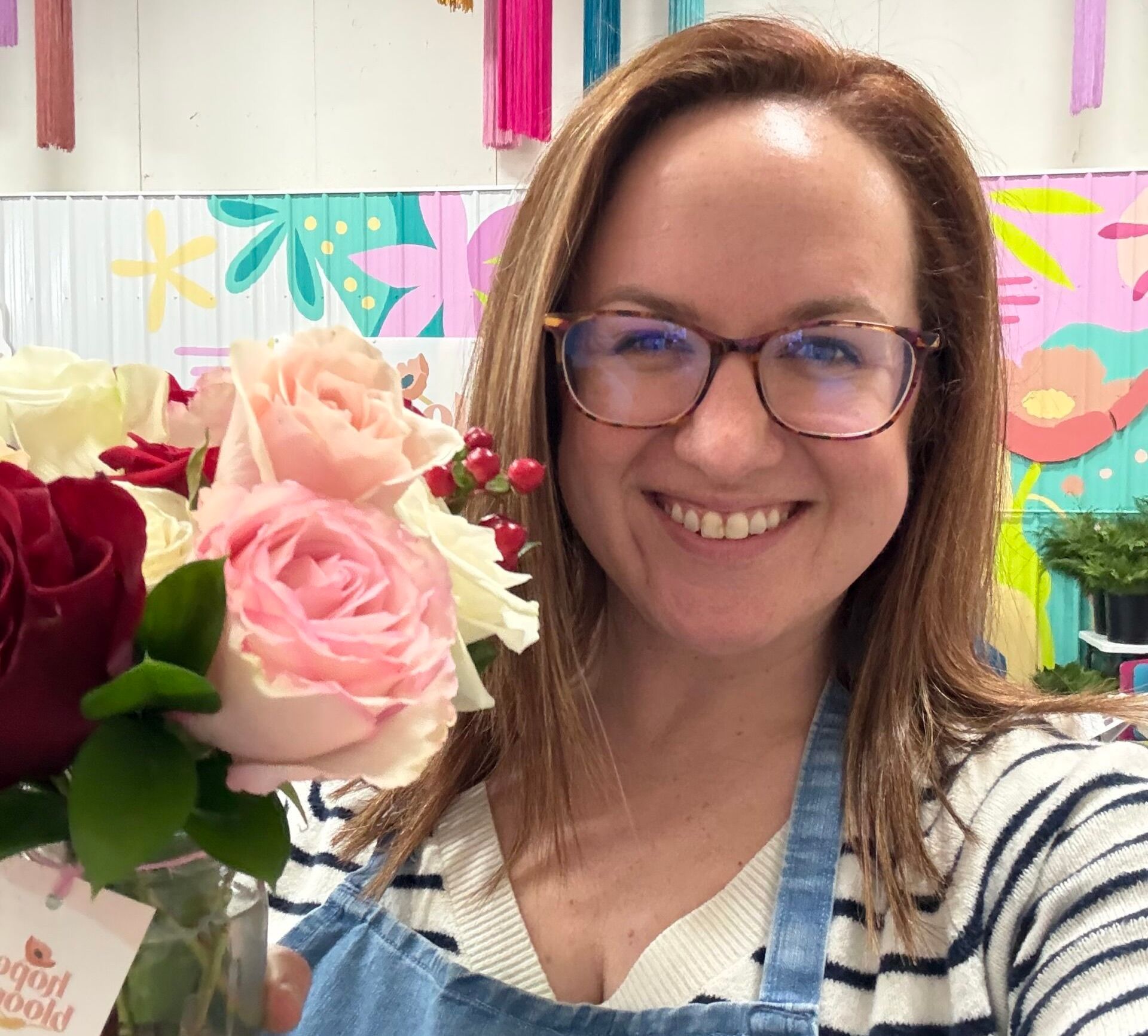 Hannah with a bouquet she made while volunteering at Hope Blooms