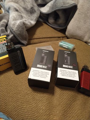 A couple of electronic cigarettes sitting on top of a couch.