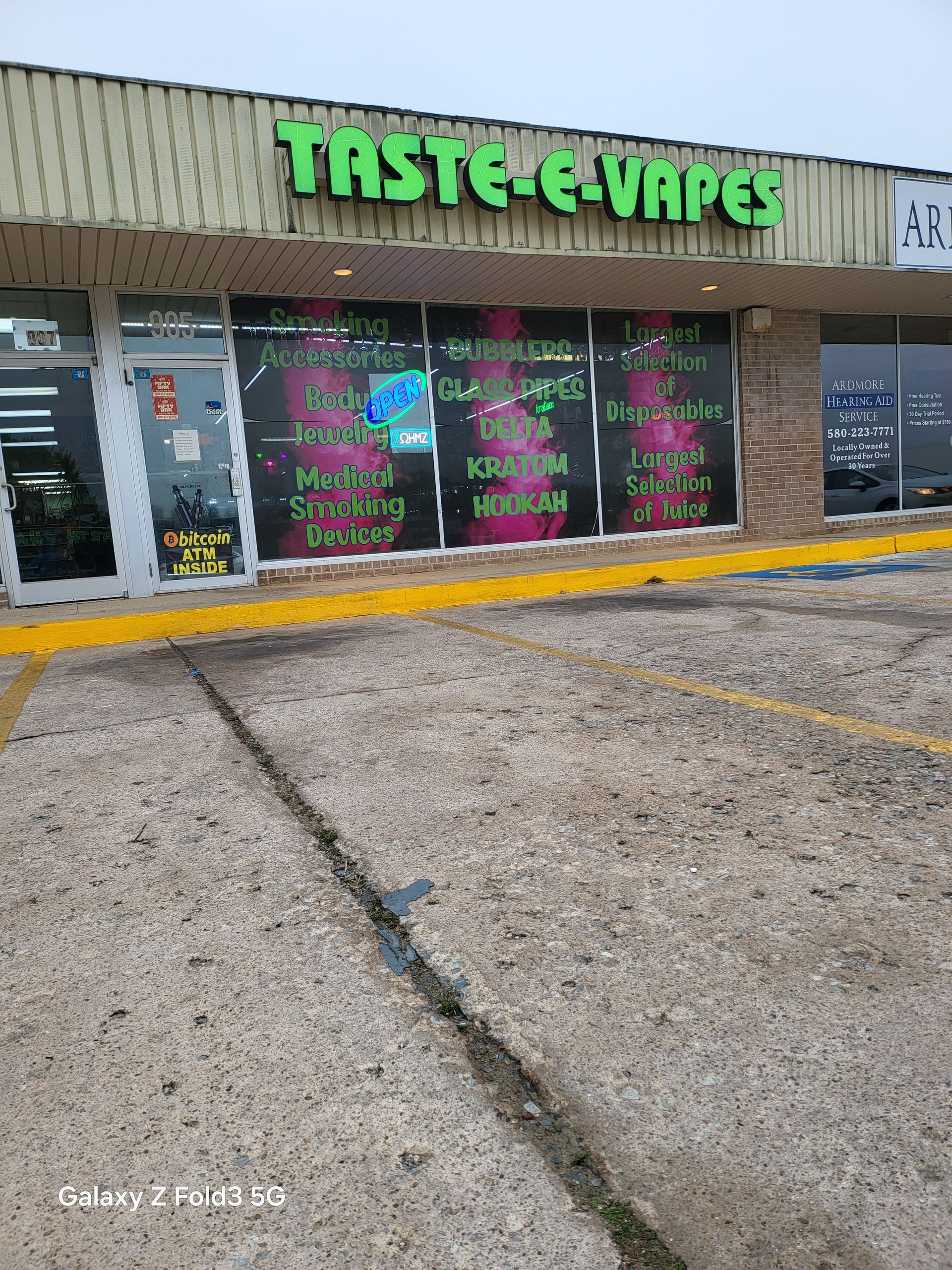 A store front with a lot of windows and a sign that says taste e-vapes.
