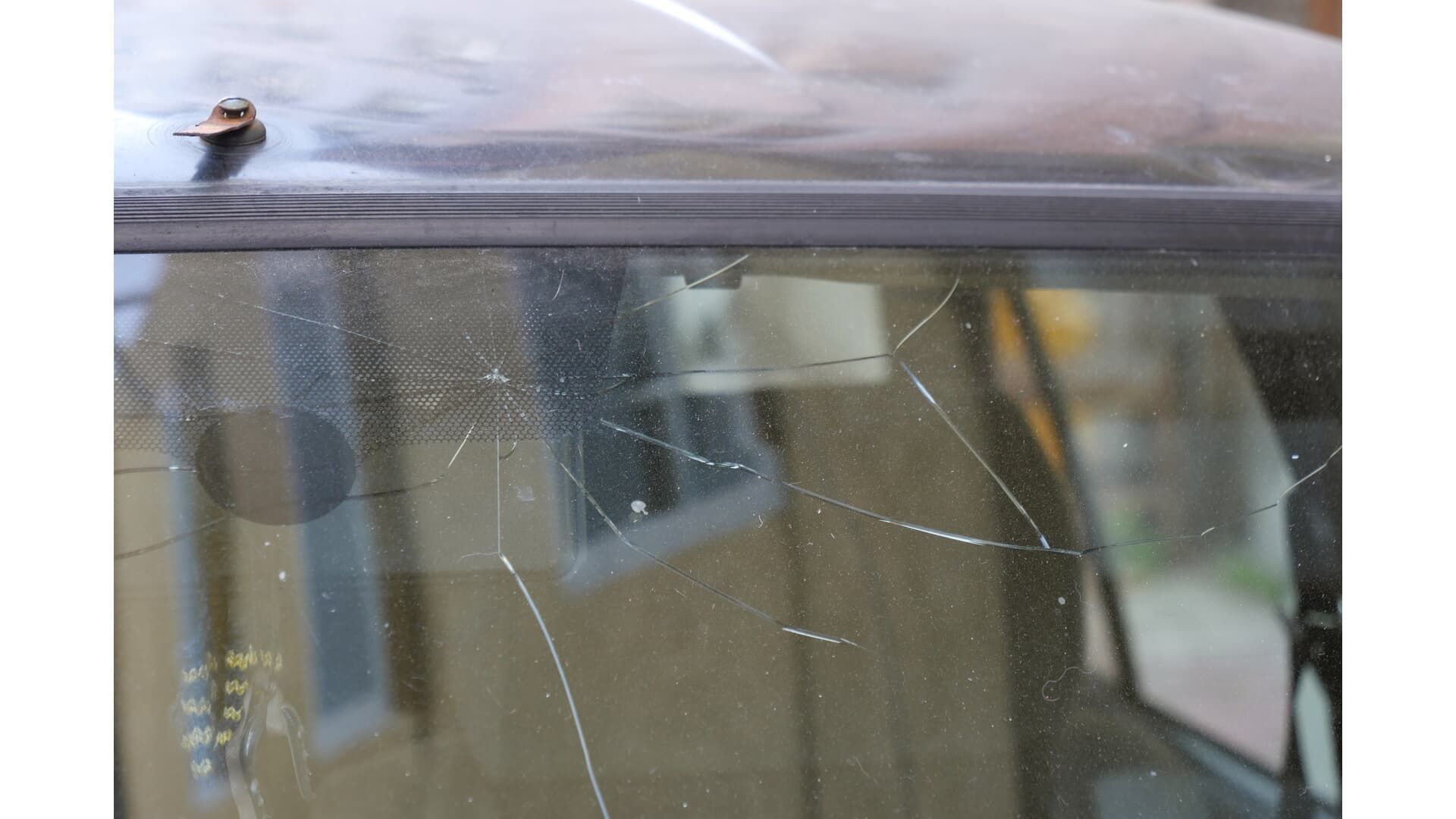 A close up of a broken windshield on a car.