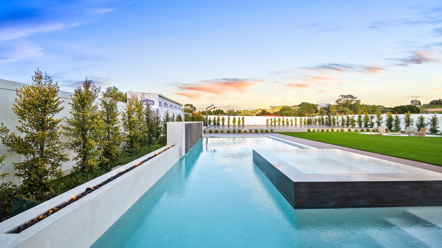 Custom pool and outdoor living project complete with a full court basketball court and outdoor kitchen. Project by Westmod. Location = Santa Clarita, CA.