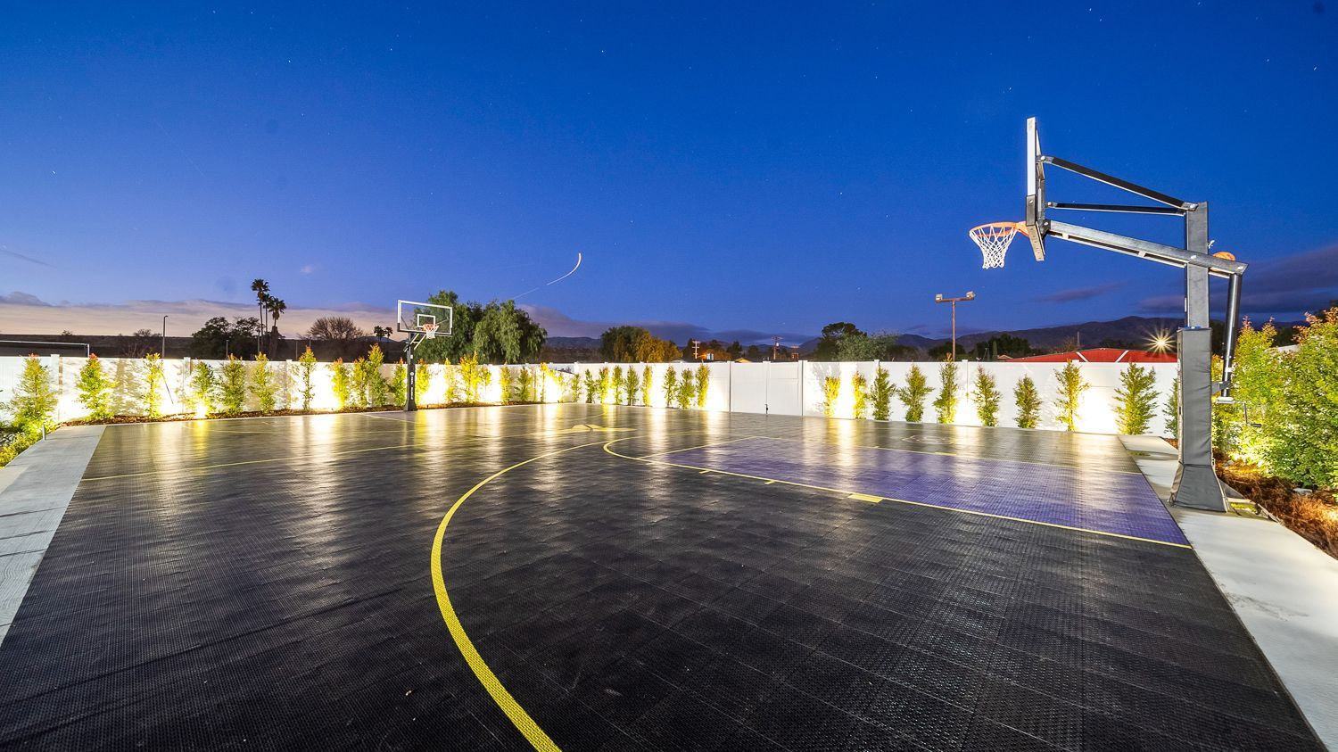 Custom pool and outdoor living project complete with a full court basketball court and outdoor kitchen. Project by Westmod. Location = Santa Clarita, CA.