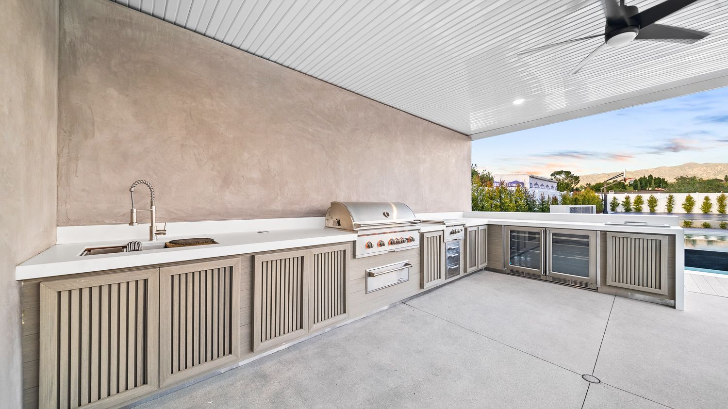 Custom pool and outdoor living project complete with a full court basketball court and outdoor kitchen. Project by Westmod. Location = Santa Clarita, CA.