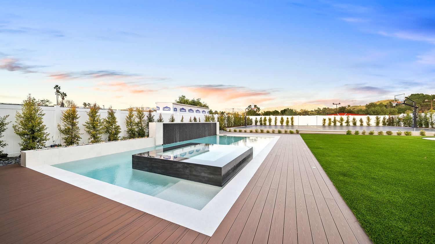 Custom pool and outdoor living project complete with a full court basketball court and outdoor kitchen. Project by Westmod. Location = Santa Clarita, CA.