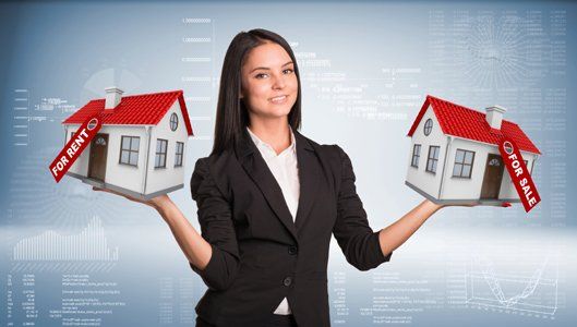 Businesswoman holding houses in hands