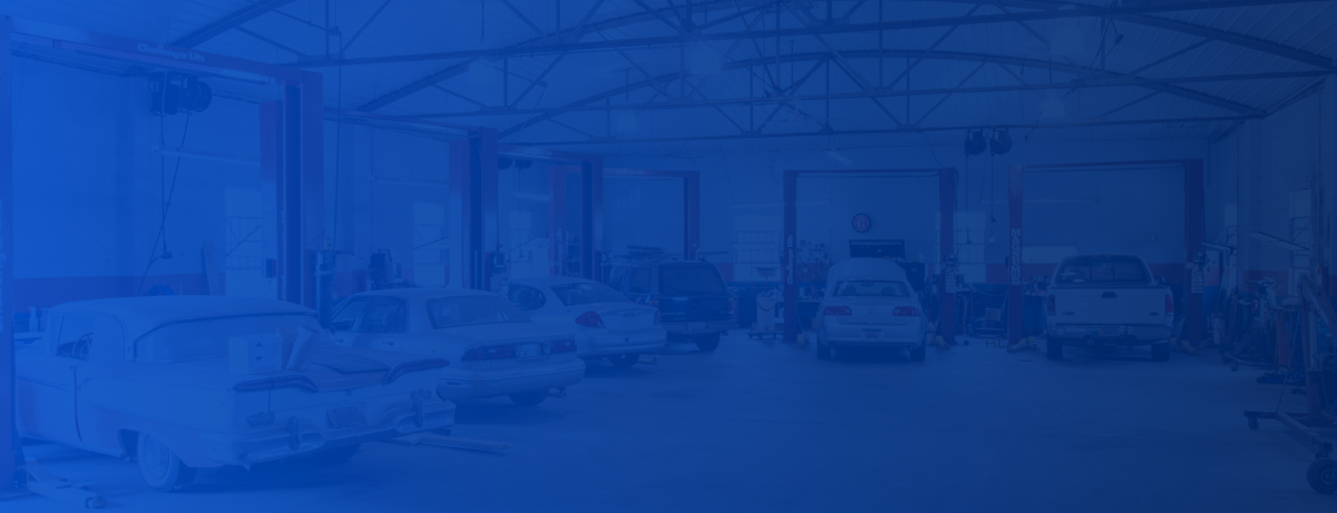 A blurry picture of a warehouse with a blue background | Team 1 Automotive