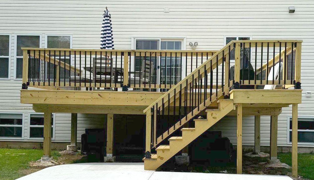 A wooden deck with stairs leading up to it