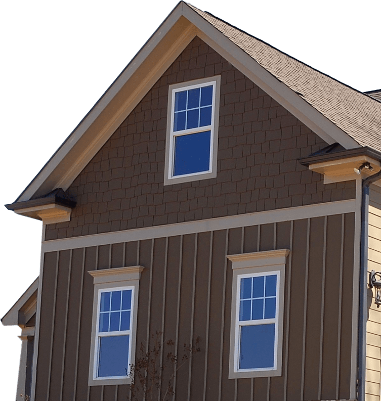 A brown house with two blue windows on the roof