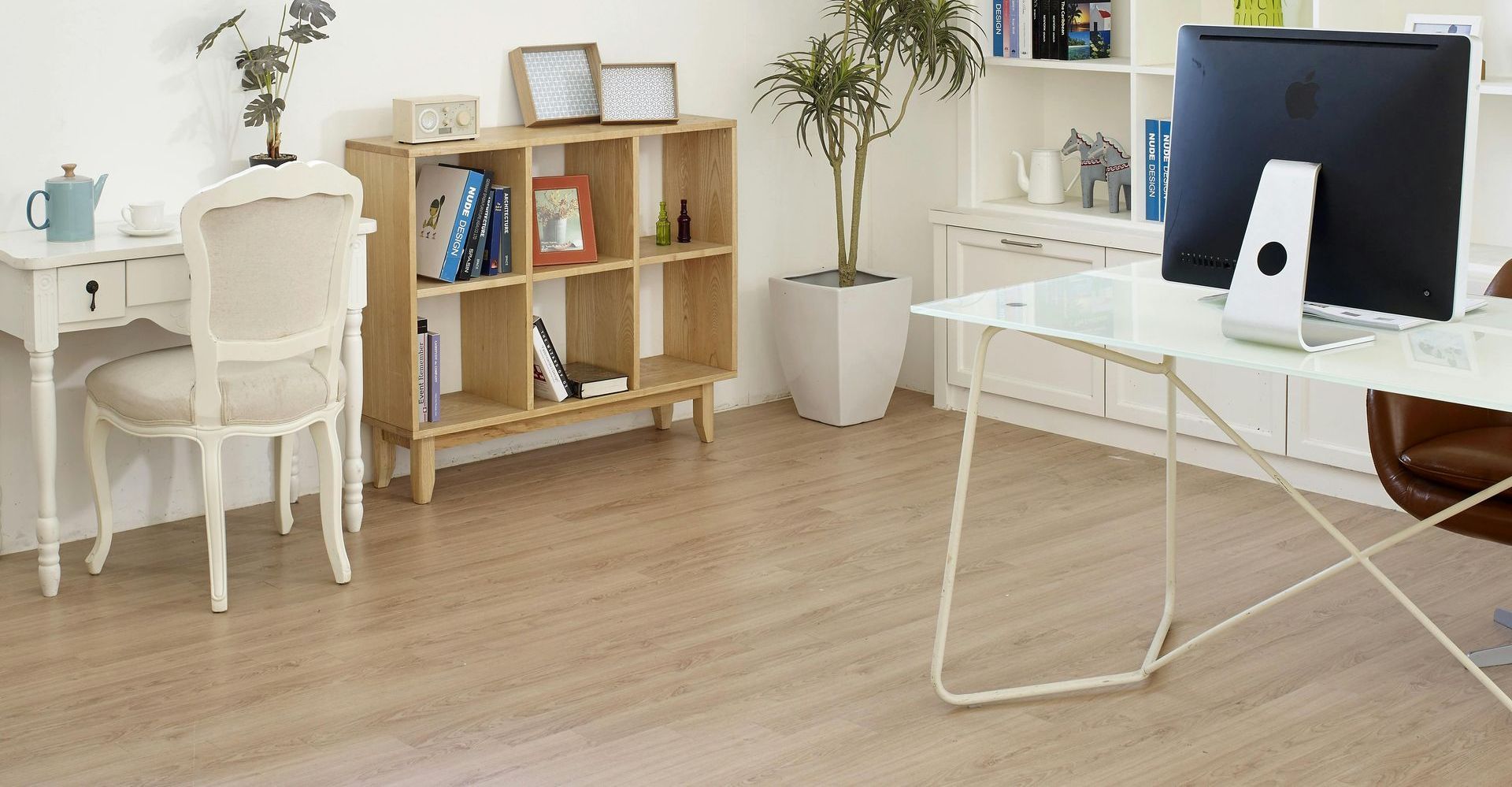 There is a desk with a computer on it in the middle of the room.