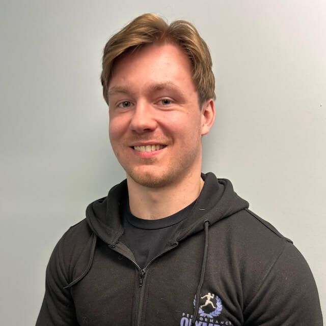 Coach Max Daigle wearing a black hoodie with the word Olympia on it