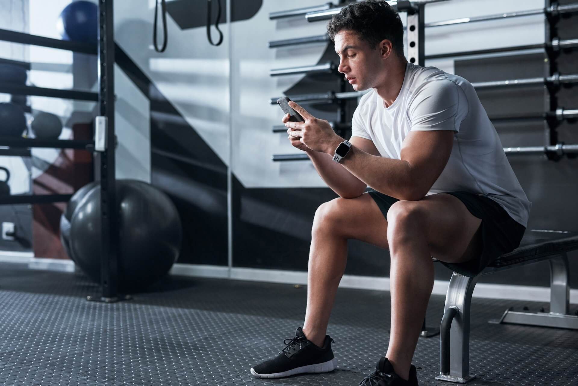 An athlete with a mobile device during a remote high-performance training session with Olympia Performance Gym in Montreal