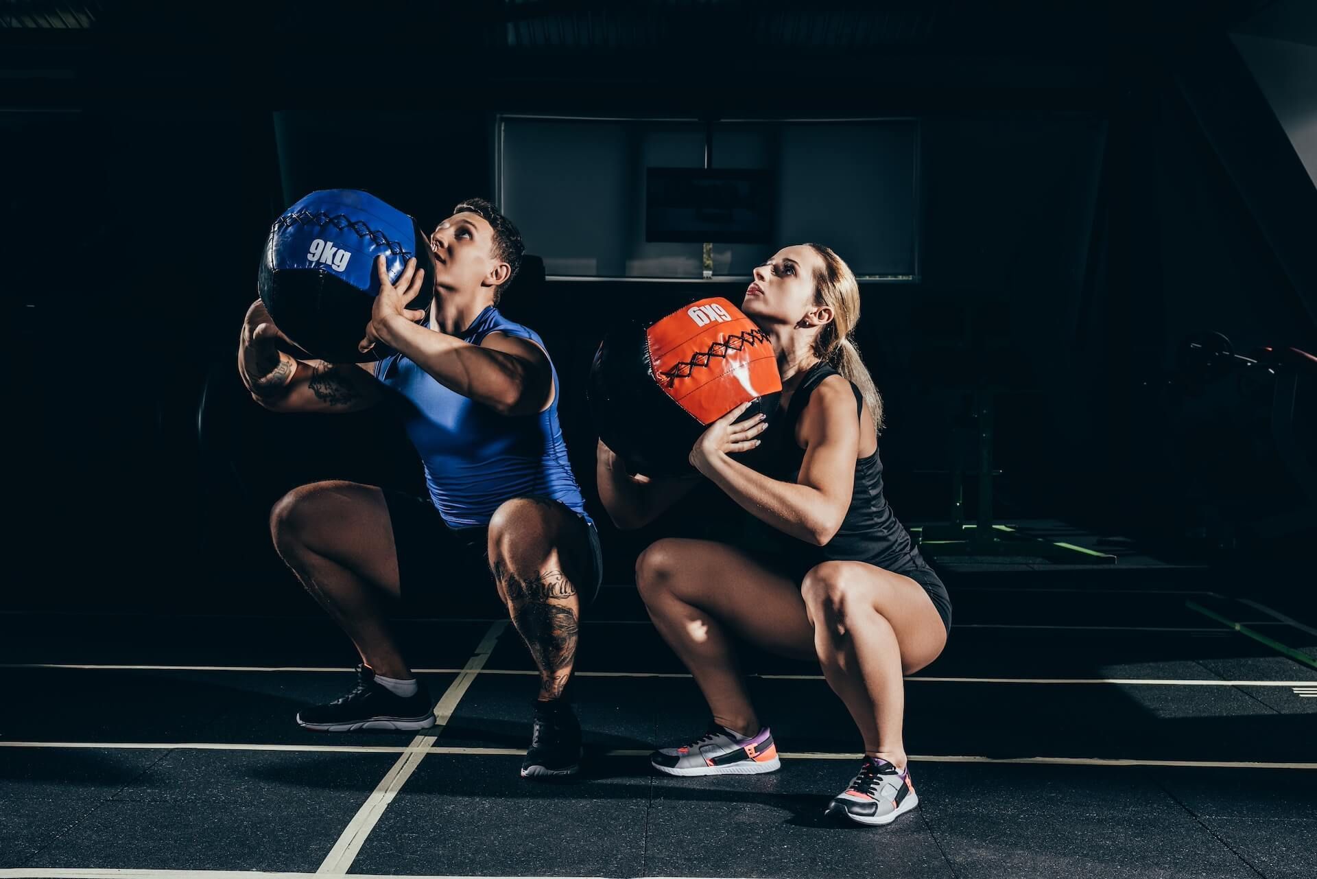 A woman athlete from Team Olympia Performance is pulling a rope during a HYROX competition event