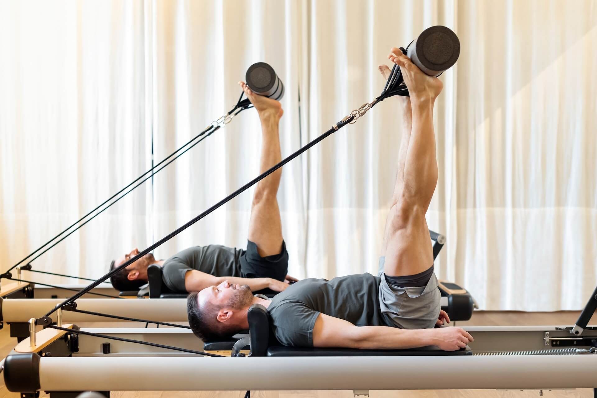 Hockey players doing Pilates on Reformers, at Olympia Performance, in Montreal's West-Island 