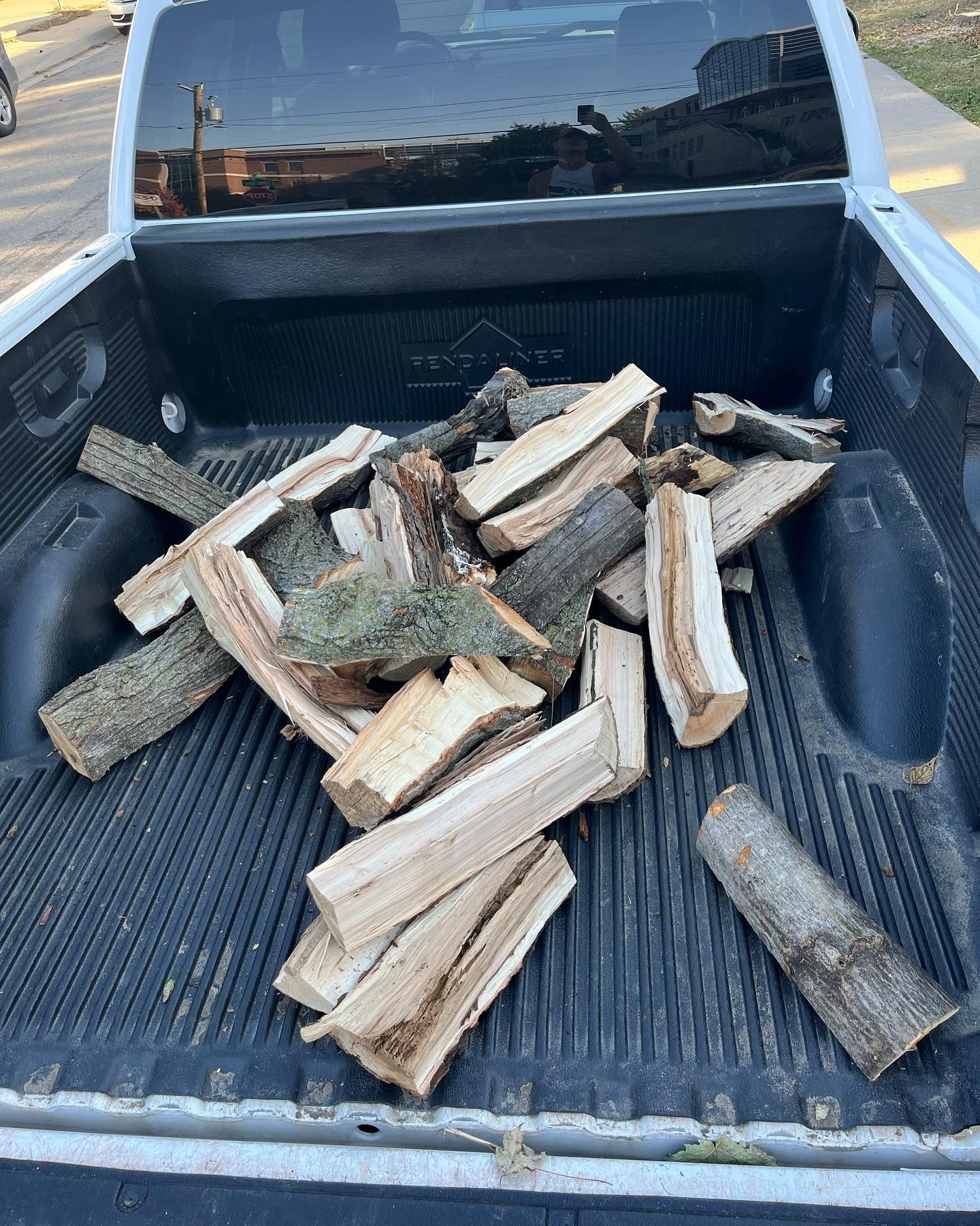 A pile of wood is in the back of a truck.