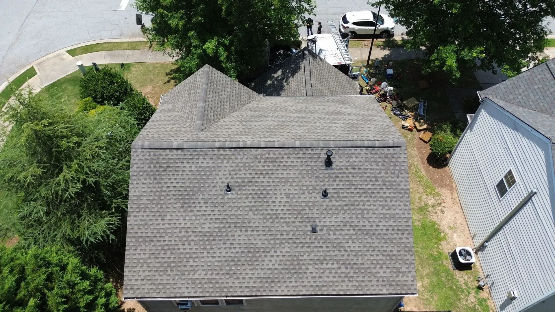 An aerial view of a house with a roof that is being repaired.