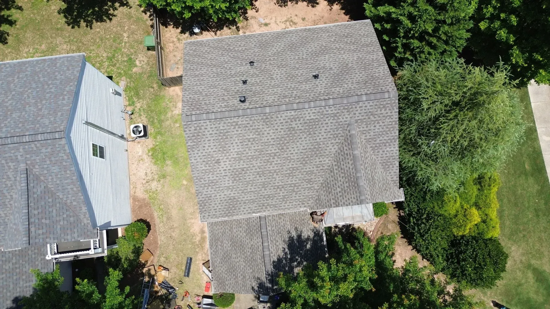 An aerial view of a house with a roof that is being installed.
