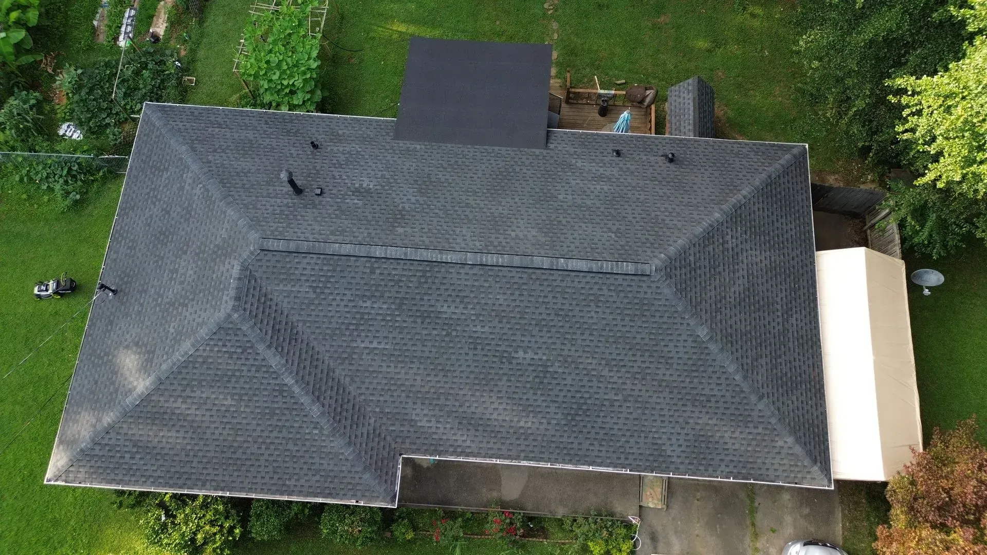 An aerial view of a house with a black roof