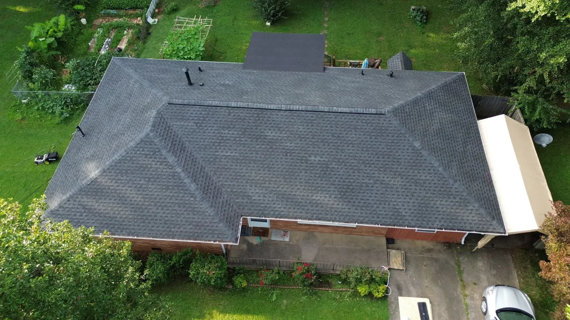 An aerial view of a house with a car parked in front of it.