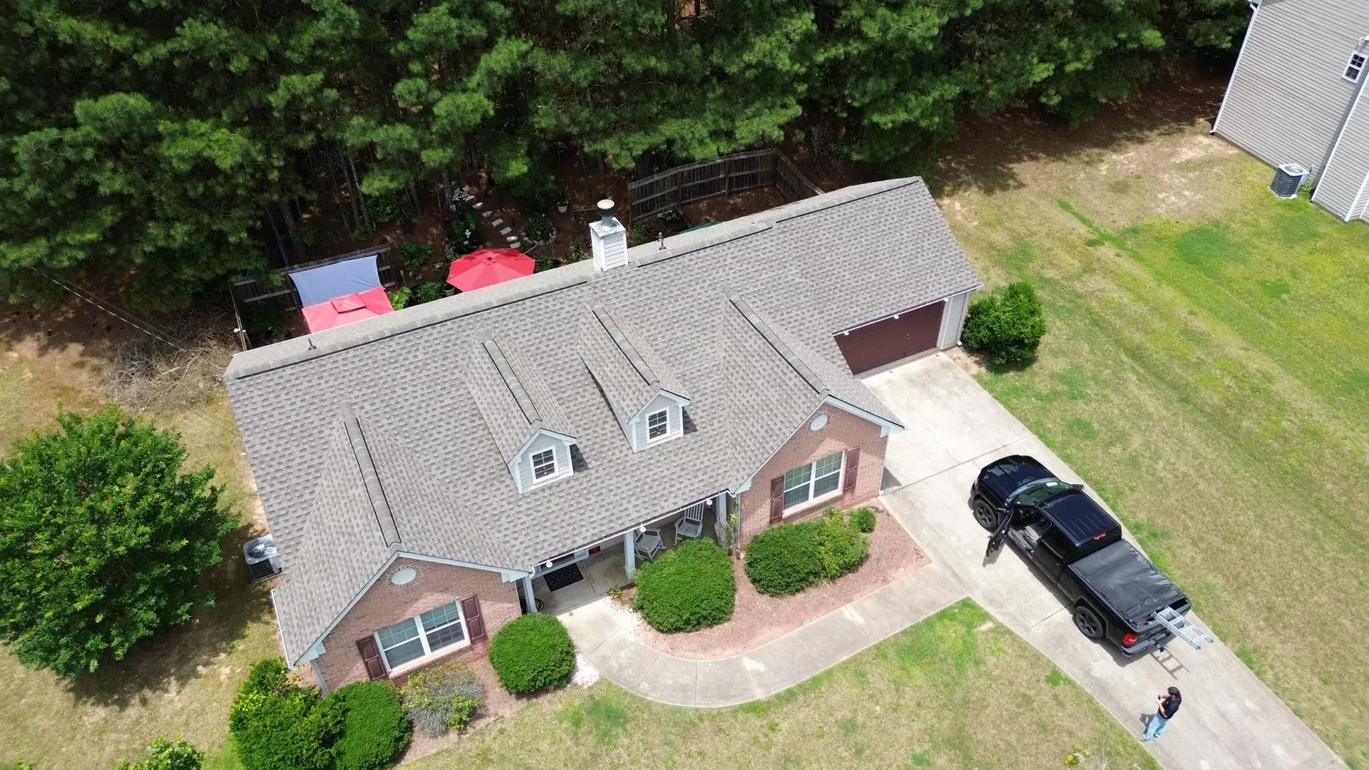 An aerial view of a house with a truck parked in front of it.