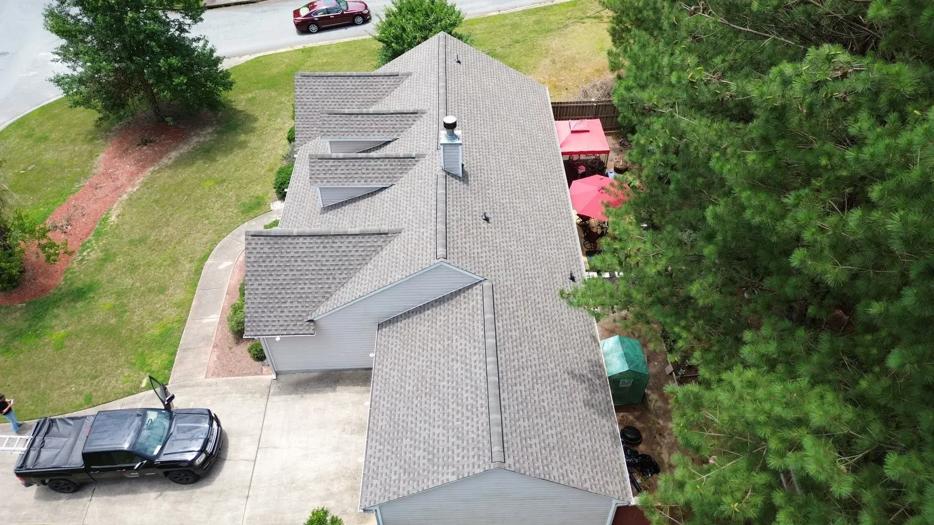 An aerial view of a house with a truck parked in front of it.