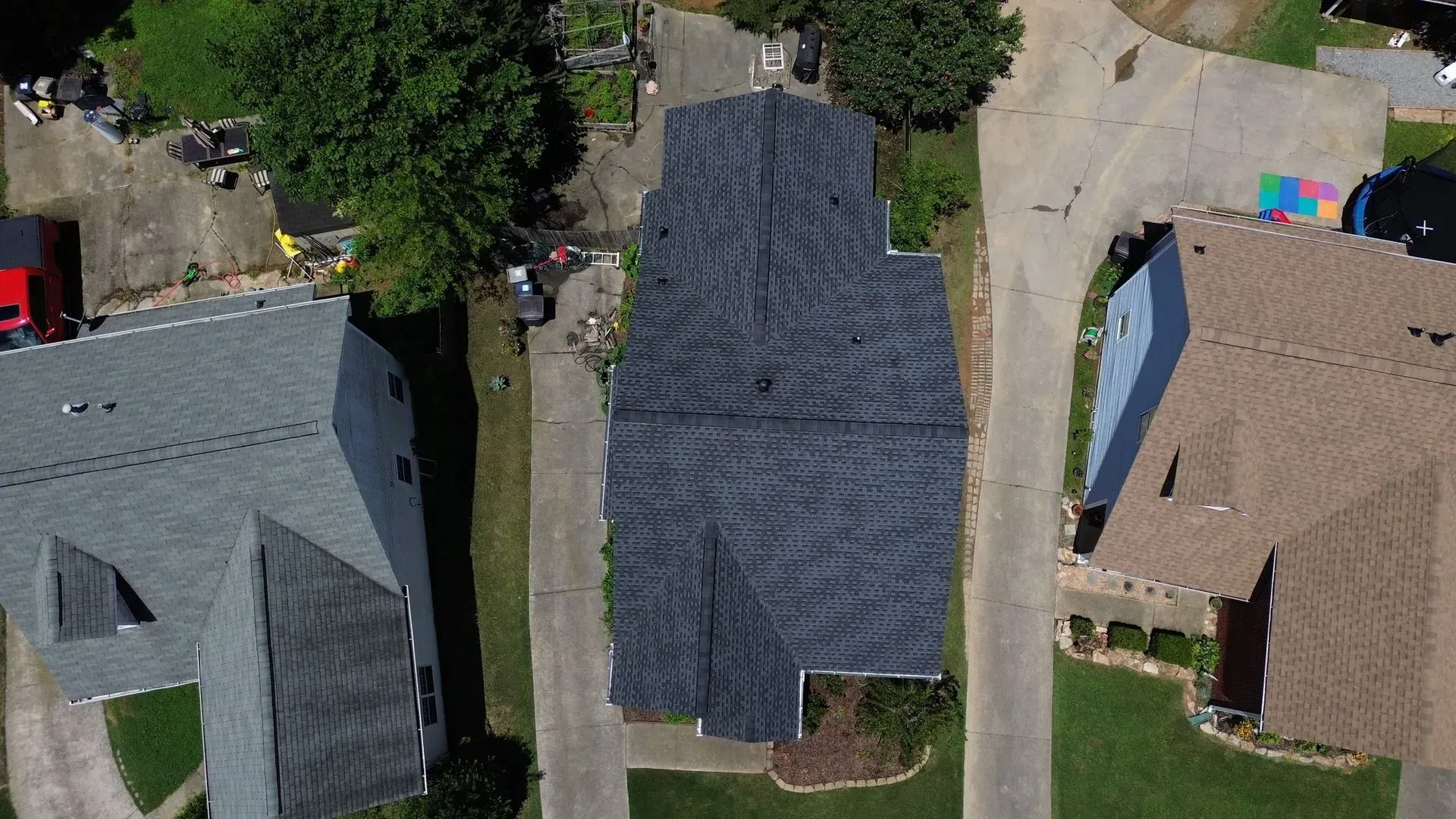 An aerial view of a row of houses with roofs that are being repaired.