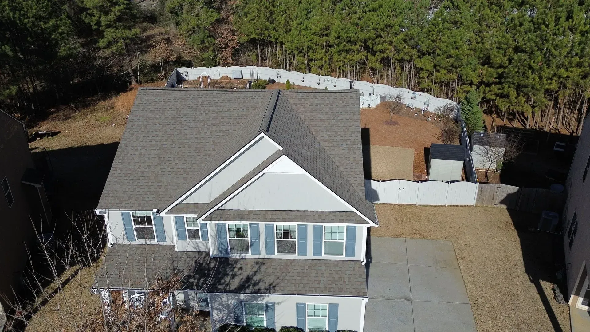 An aerial view of a house with a gray roof