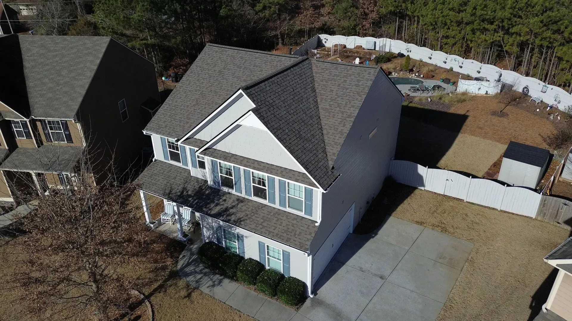 An aerial view of a house with a gray roof