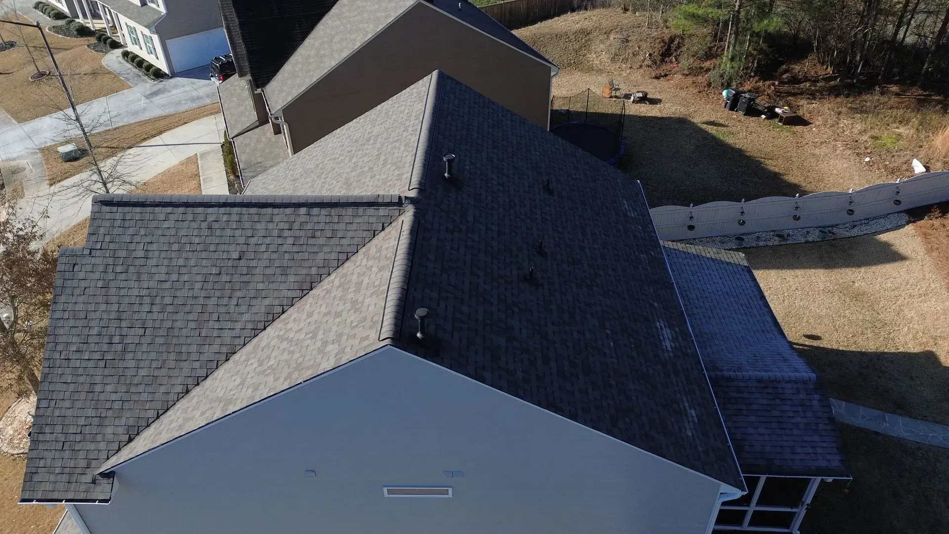 An aerial view of a house with a black roof