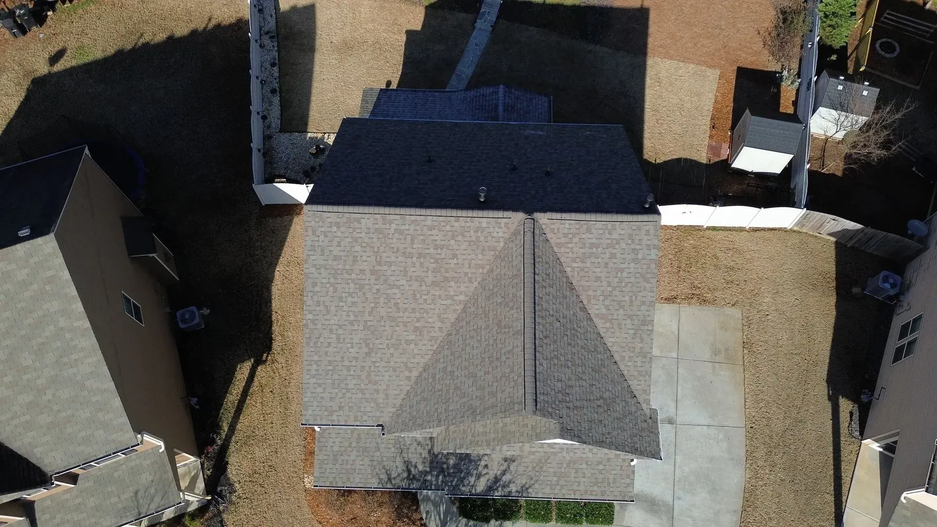 An aerial view of a house with a pyramid shaped roof