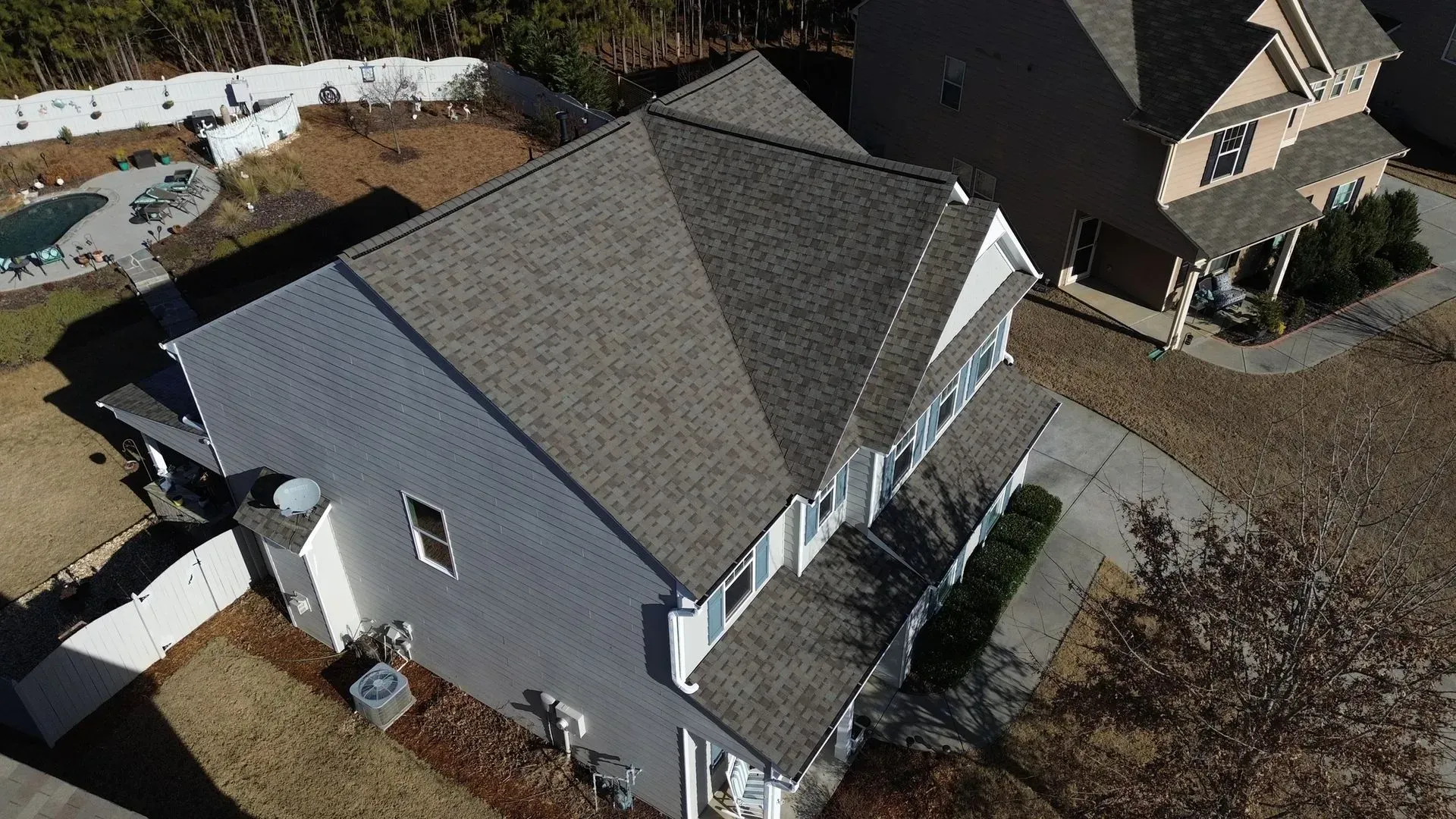 An aerial view of a large house with a gray roof.