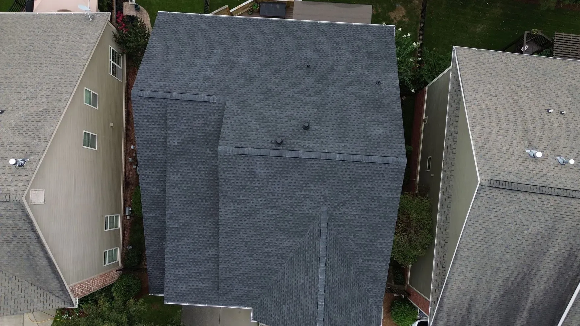 An aerial view of a house with a new roof.