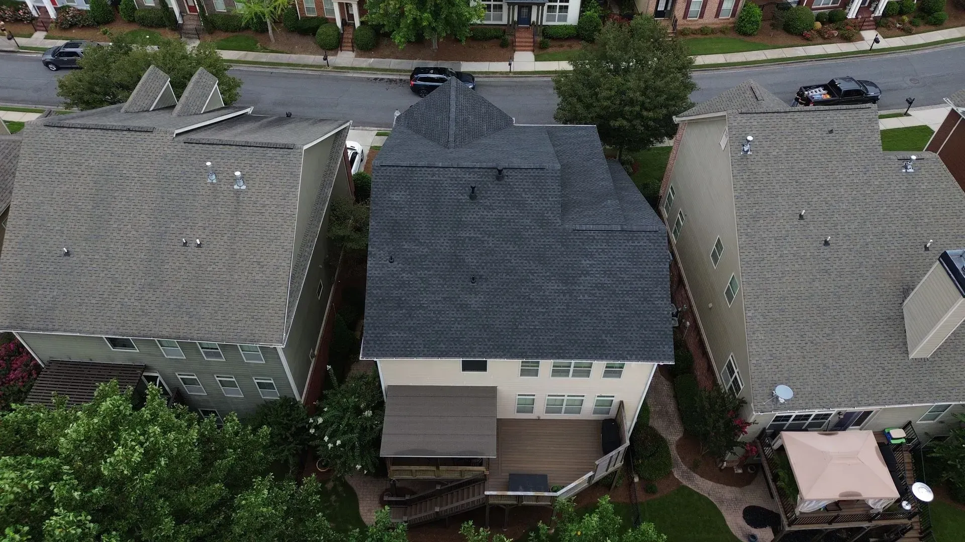 An aerial view of a residential neighborhood with a large house in the middle.