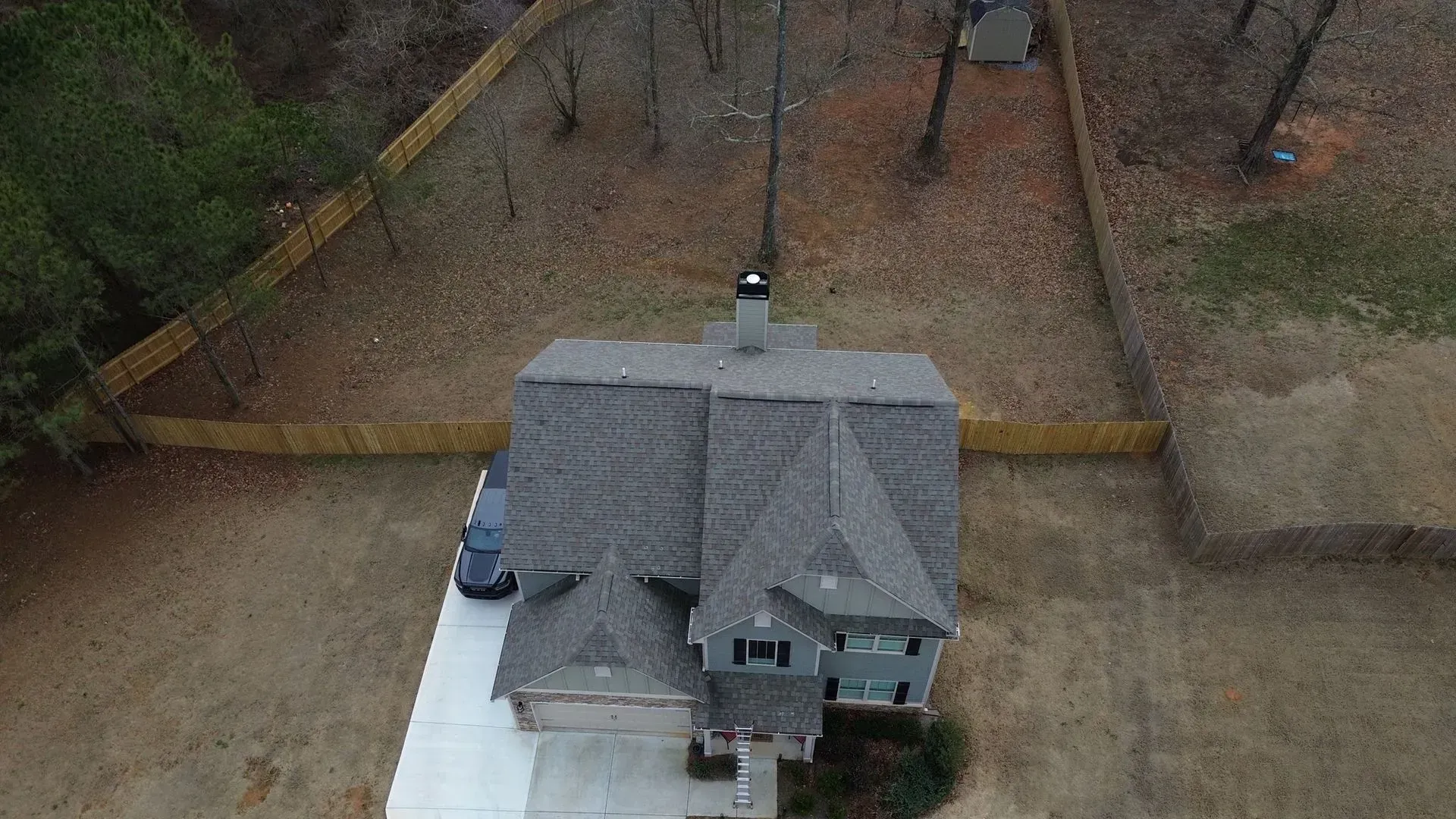 An aerial view of a house with a car parked in front of it.
