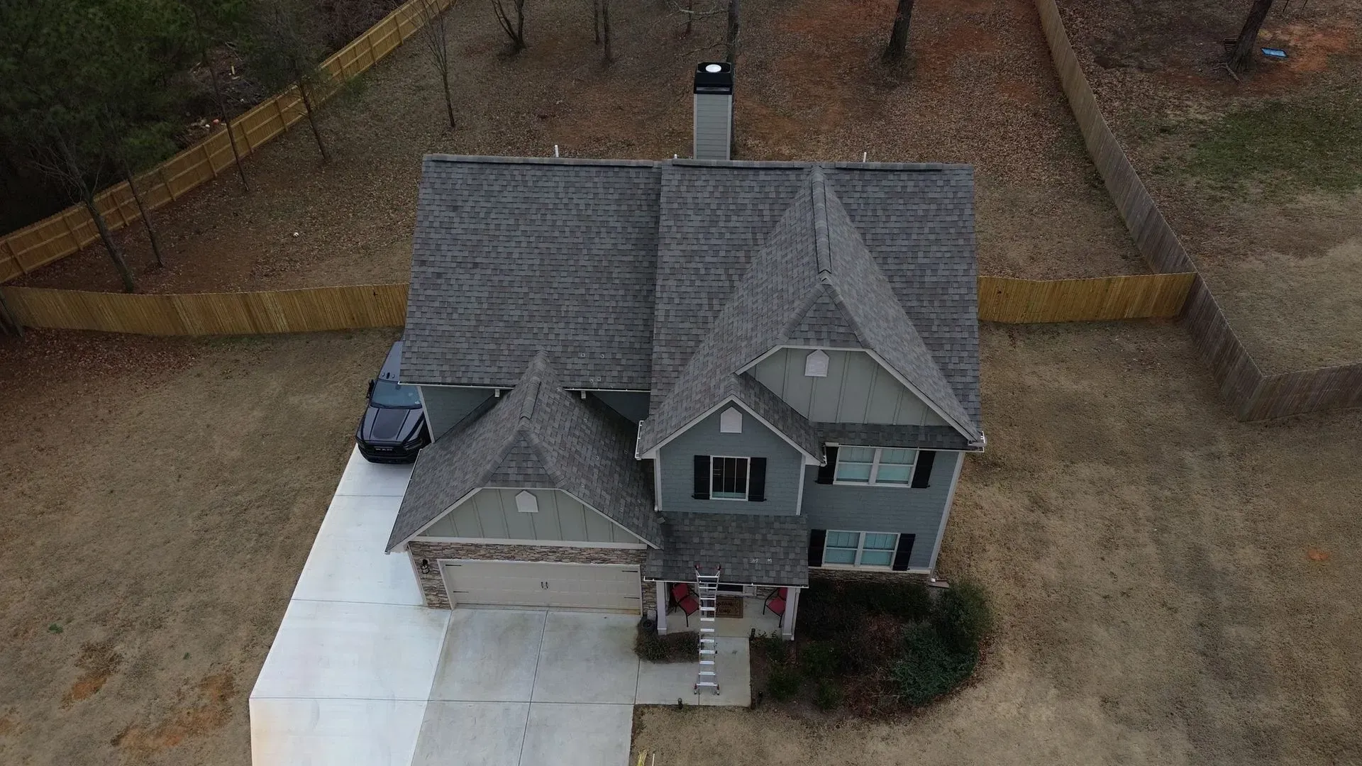 An aerial view of a house with a car parked in front of it.
