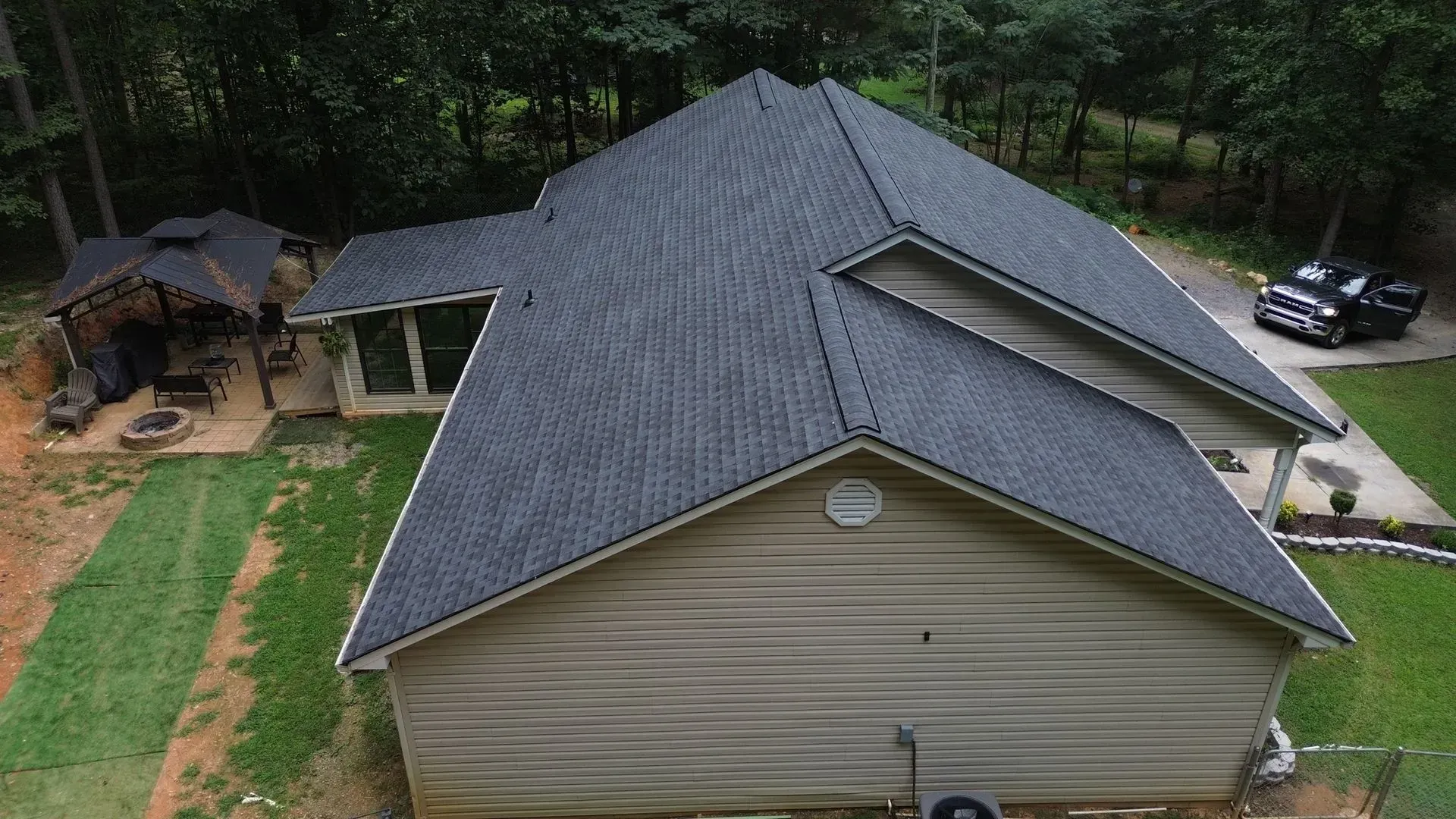 An aerial view of a house with a new roof.