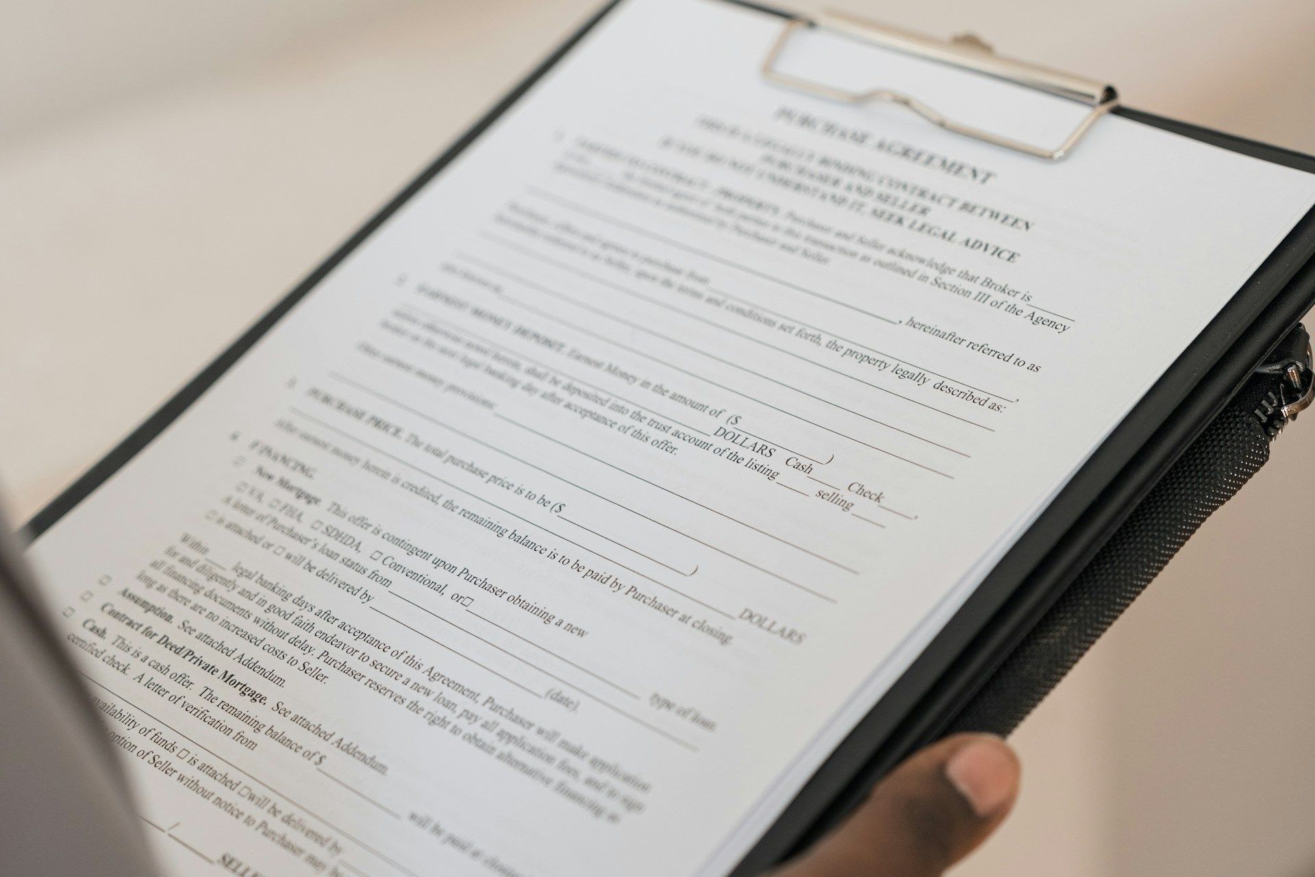 A person is holding a clipboard with a piece of paper on it.