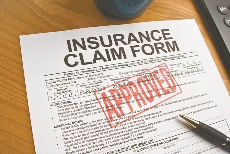 A pen is sitting on top of an insurance claim form
