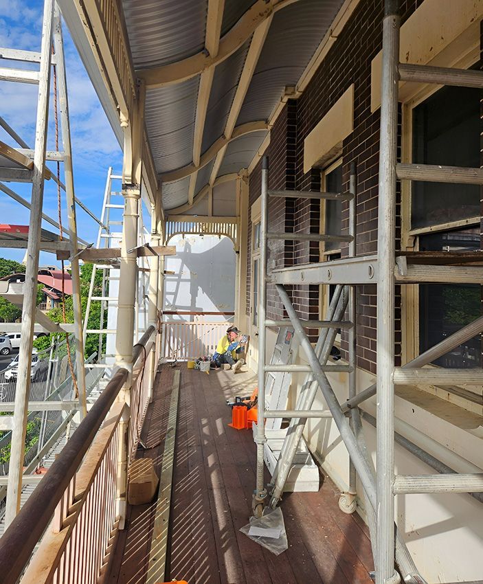 A Balcony with Scaffolding and a Ladder on It — Chops Painting in Coral Cove, QLD