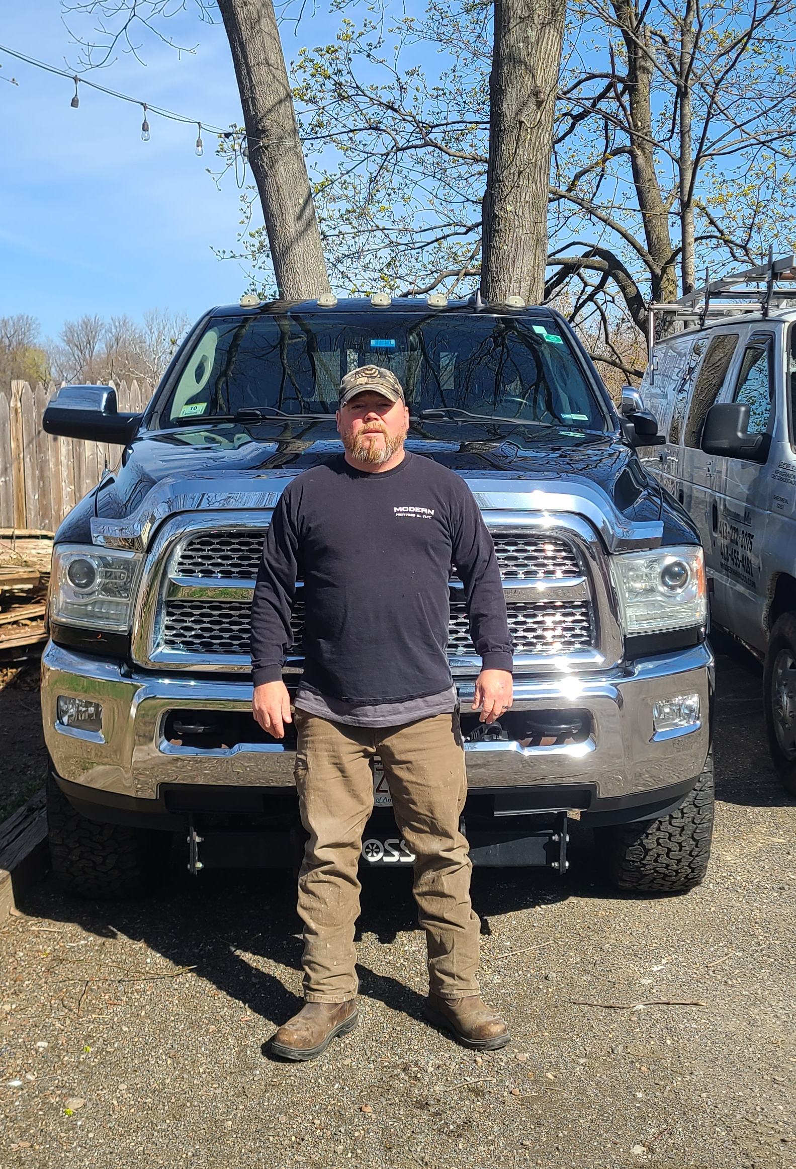 A man is standing in front of a truck.