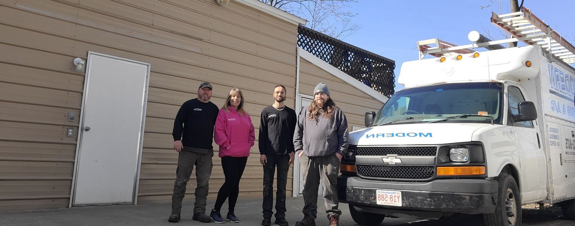 A group of people standing in front of a van that says ' ambulance ' on it