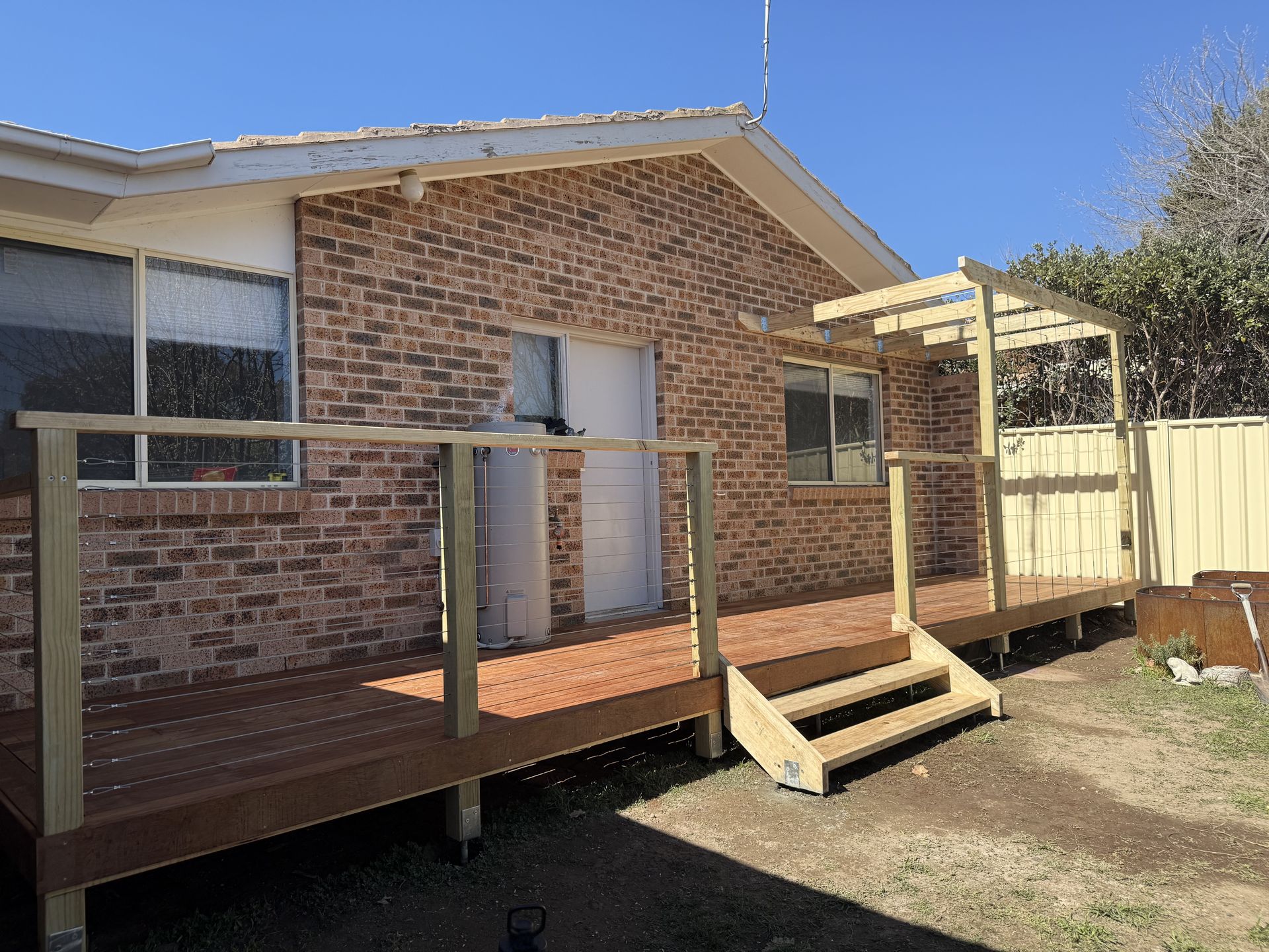 A white house with a wooden deck in front of it