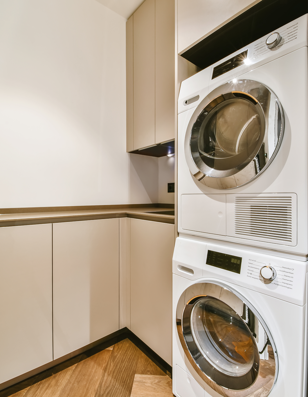 A laundry room with a washer and dryer and a window